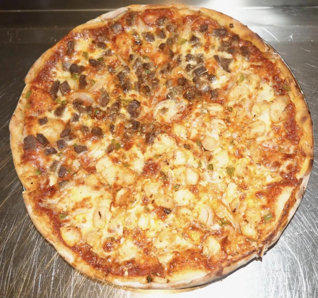 Large  Hot & Spicy Pizza Freshly baked dough topped with pizza sauce, hot pepper, mozzarella cheese, minced meat, diced chicken, and vegetables.